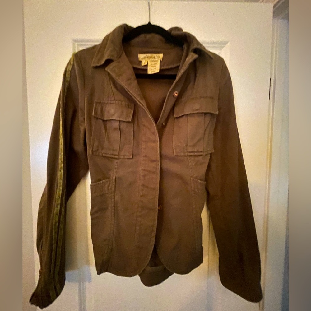 Rugged military style jacket with zip accents on the sleeves button up